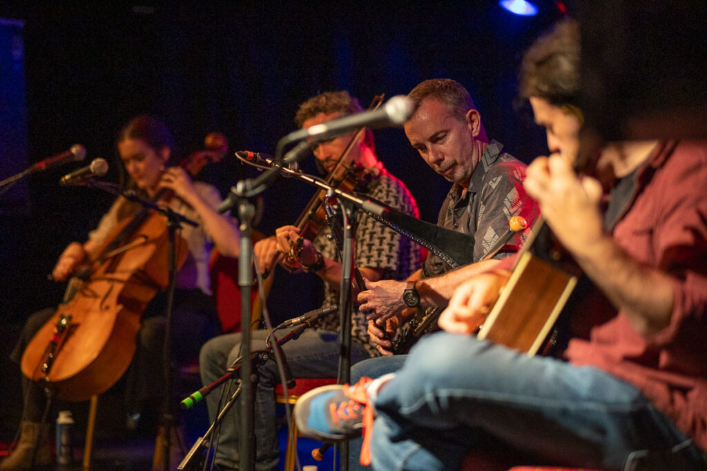 Group performance with fiddle, pipes, guitar and cello – Irish Folk Concert Photography